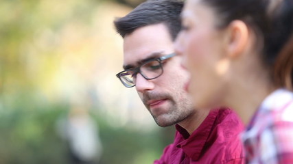 Young couple playing guitar and singing in park - Powered by Adobe