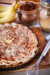 Banoffee pie with whipped cream and chocolate