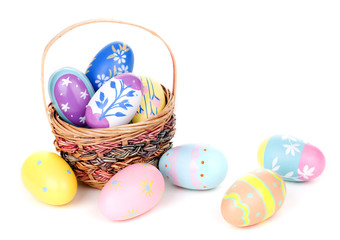 Assortment of Colorful Easter Eggs and Basket on a White Background
