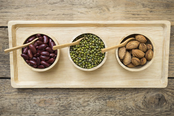 Group of beans on wood table background