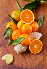 Fresh citrus with ginger on a wooden background