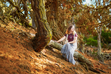 Beautiful young romantic girl sitting in Presidio park in San Francisco - obrazy, fototapety, plakaty