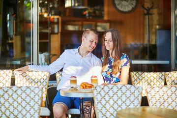 Young romantic couple in a cozy outdoor cafe in Paris, France © Ekaterina Pokrovsky
