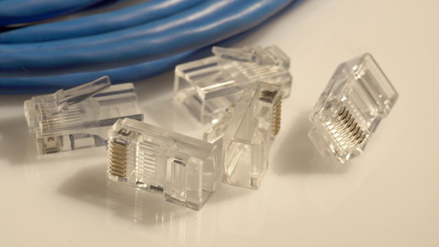 Closeup of a set of network cable and computer rj45 connectors turning
