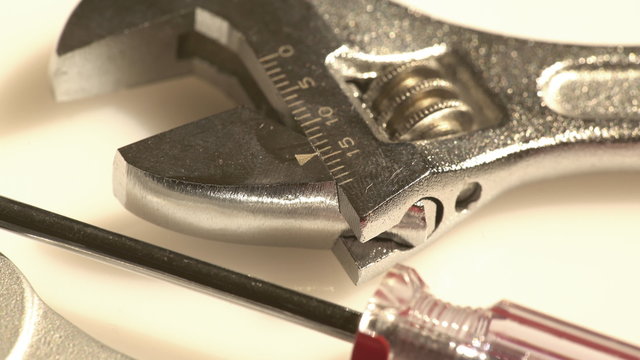 Closeup of a technical setting with an adjustable wrench and a small screwdriver