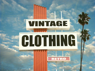 aged and worn vintage clothing sign with palm trees © jdoms