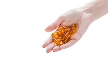 Fototapeta premium Soft gels pills with Omega-3 oil in hand closeup on white