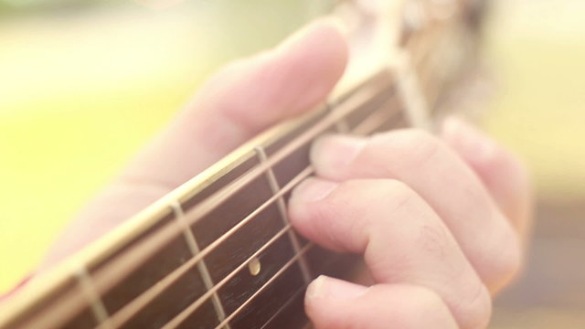 Fingers on guitar fretboard