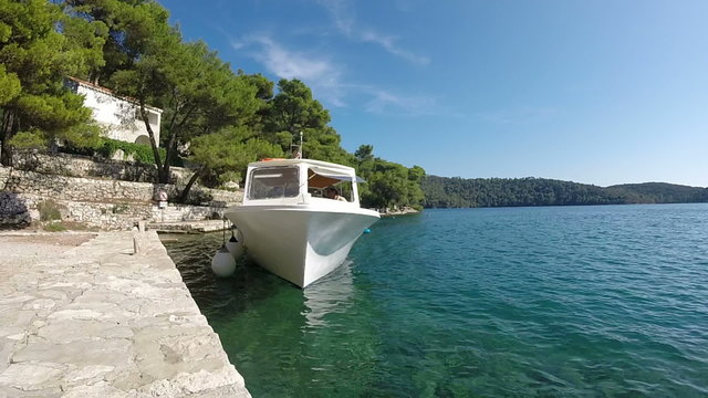 Tour boat docks at pier in Mjlet, Croatia