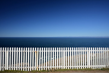 white fence with ocean background