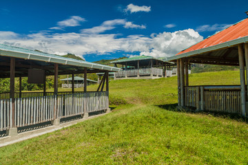 Protective roofs over ancient tombs located in Segovia site in Tierradentro, Colombia.