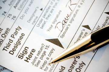 Taxes: Signing Tax Form With Fancy Pen