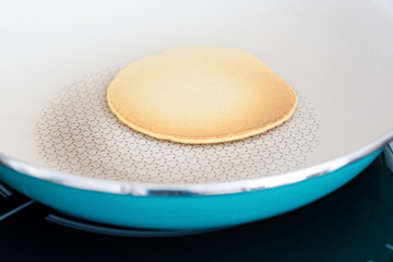 Making home made pancakes on frying pan