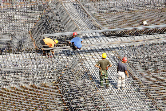 worker in the construction site making reinforcement metal frame