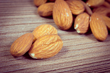 Vintage photo, Heap of almonds on wooden background