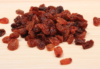Brown raisins on wooden table, healthy eating