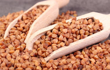 Buckwheat groats with spoon on cement structure