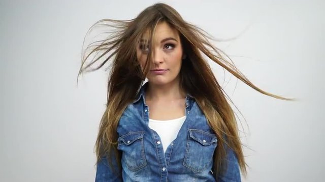 Woman feeling her hair as it blows in the wind  4K