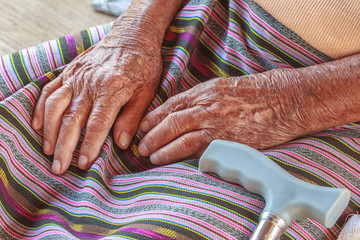 Closeup old hand with crutch
