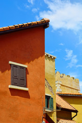 Fototapeta na wymiar Italian building colorful classic style on blue sky