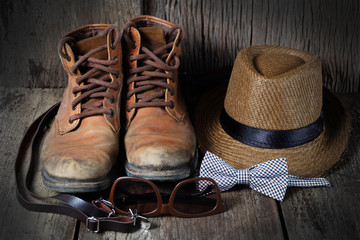 Shoe hat and accessories travel set on a wooden background