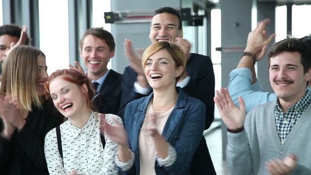 Close up of happy business people, laughing and clapping