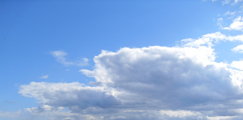 Cloudy sky. The blue sky with white cumulus clouds fantastically shaped
