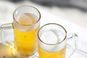 Glasses of beer on beach