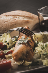 Fried fish with lettuce, lemon and tomato