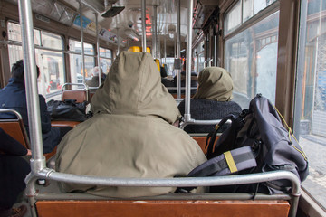 Obraz na płótnie Canvas Man in winter coat sitting in tram