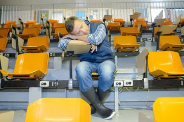 Man in wellingtons asleep on desk