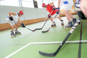 Men playing roller hockey