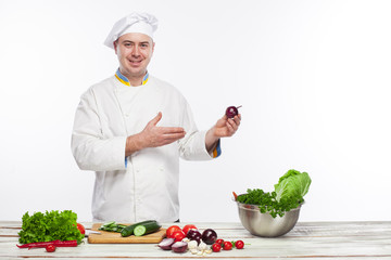 Chef cooking fresh vegetable salad in his kitchen