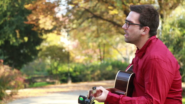 Man playing the guitar and singing