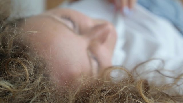 Sexy Beautiful Sensual Woman Lying on Bed Unbuttons Blouse