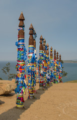 Fototapeta premium Buryat traditional pillars with colored ribbons by Lake Baikal
