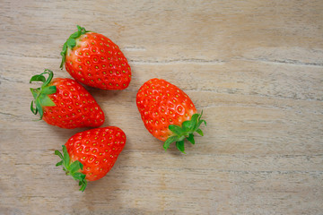 Fresh strawberries on wooden background