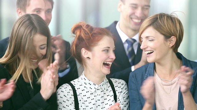 Portrait of happy business people clapping