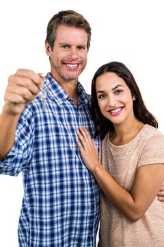 Portrait of happy couple holding home keys
