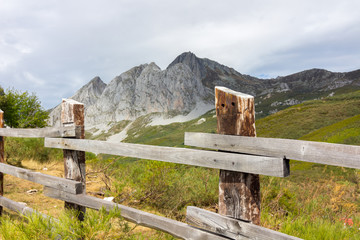 Fototapeta na wymiar wooden fence in high mountain meadow