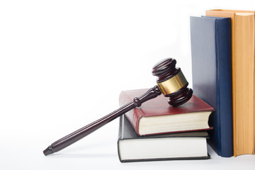 Law book with a wooden judges gavel on table in courtroom 
