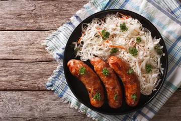 Photo sur Plexiglas Plats de repas grilled sausages and sauerkraut close-up. Horizontal top view  