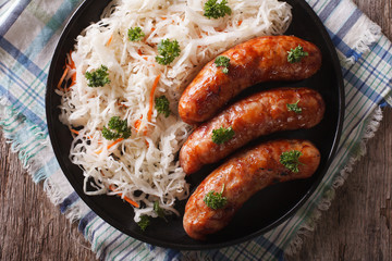 German bratwurst and sauerkraut on the table. Horizontal top view

