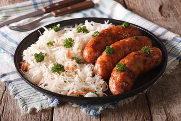 German bratwurst and sauerkraut on the table. horizontal
