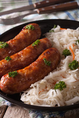 Grill sausages and sauerkraut on a plate close-up
