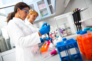 Photo of real female scientists researching in laboratory.