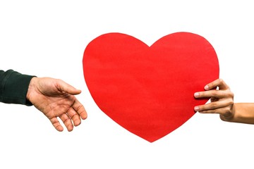 Cropped hand of woman giving heart shaped paper to man