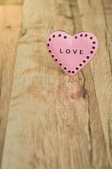 Valentines Day heart with inscription/Pink heart with place for text on the wooden background