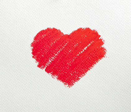 Close up of lipstick heart shape on white background.