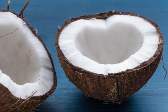Chopped coconut: coconut halves in the shape of a heart on a blu